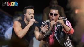 FILE - Singers Luis Fonsi, left and Daddy Yankee perform during the Latin Billboard Awards in Coral Gables, Fla., April 27, 2017. Malaysia has banned their hit song 