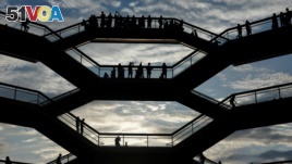 People tour the inside 'The Vessel,' a large public art sculpture made up of 155 flights of stairs at the Hudson Yards development, a residential, commercial, and retail space on Manhattan's West side in New York City, New York, U.S., May 26, 2019. 