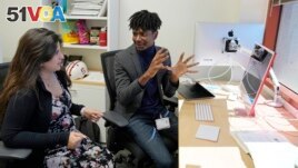 Post-doctoral researcher Tofunmi Omiye, right, gestures while talking in his office with assistant professor Roxana Daneshjou at the Stanford School of Medicine in Stanford, Calif., Tuesday, Oct. 17, 2023. (AP Photo/Eric Risberg)