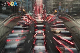 FILE - In this slow-shutter zoom effect photo taken Dec. 12, 2018, commuters are backed up in traffic during the morning rush hour in Brussels, a city that regularly experiences pollution alert warnings.