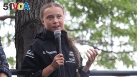 Greta Thunberg, a 16-year-old Swedish climate activist, speaks in front of a crowd of people after sailing in New York harbor aboard the Malizia II, Wednesday, Aug. 28, 2019. 