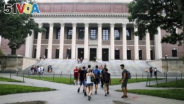FILE - Students walk near the Widener Library at Harvard University in Cambridge, Massachusetts, Aug. 13, 2019. 