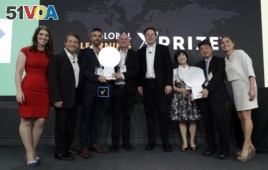 Representatives from onebillion, Jamie Stuart, third from left, and Andrew Ashe, fourth from left, and representatives from KitKit School, Sooinn Lee, third from right, and Gunho Lee, second from right, receive the XPRIZE Children's Literacy award.