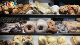 A selection of pastries, including doughnuts, bagels, rolls, croissants, turnovers and sticky buns are displayed in a New York coffee cart. (File Photo)