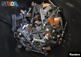 Hand guns turned in by their owners lie in a trash bin in Los Angeles. The Los Angeles Police Department held a buy-back to get guns off the street. The program to buy guns followed the  mass shooting at Sandy Hook Elementary School in Connecticut on December 26, 2012.