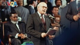 South African President F.W. de Klerk, right, marks the end of South Africa's rule of Namibia during independence celebrations, in Windhoek, Namibia, March 21, 1990. (AP Photo/John Parkin/File)