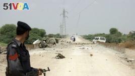 A policeman stands guard at the site of a roadside bomb outside Dera Ismail Khan, northwest Pakistan. (File)