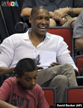 Toronto Raptors general manager Masai Ujiri watches his team play against Denver Nuggets during an NBA summer league basketball game on Saturday, July 12, 2014, in Las Vegas. Ujiri is from Nigeria.
