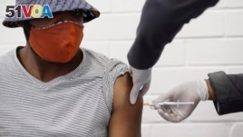 A volunteer receives a COVID-19 test vaccine injection developed at the University of Oxford in Britain, at the Chris Hani Baragwanath hospital in Soweto, Johannesburg, South Africa, June 24, 2020.