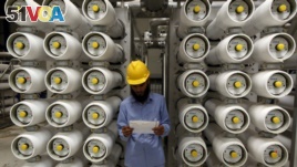 FILE - A worker stands at a desalination plant, 35 km south of Riyadh, May 4, 2011.