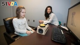 Temple University graduate student Zoe Ngo tests a young student for school's memory study.