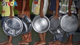 Children holding plates wait in a queue to receive food at an orphanage in the southern Indian city of Chennai. (File)