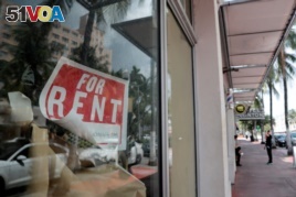 FILE - In this July 13, 2020 file photo, a For Rent sign hangs on a closed shop during the coronavirus pandemic in Miami Beach, Fla.