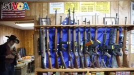 In this March 15, 2016 photo, guns for rent are on display at a shooting range and retail store in Cherry Creek, Colorado.