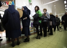 People line up at a polling station near the Vatican, in Rome, March 4, 2018.