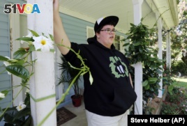 Gavin Grimm leans on a post on his front porch during an interview at his home in Gloucester, Va.  Grimm is a transgender student whose demand to use the boys' restrooms has divided the community and prompted a lawsuit. (Steve Helber/AP)