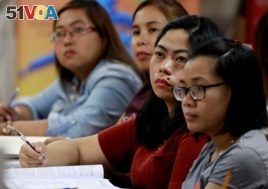 Filipino workers, including nurses applying to work in United Kingdom, attend a lecture at a review center for the International English Language Testing System or IELTS in Manila, Philippines, April 2, 2019.