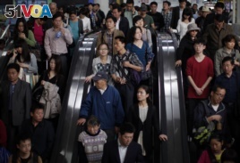 People enter a subway station in People's Square, Shanghai April 28, 2011.
