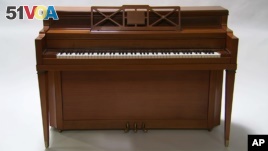 This April 5, 2016 image taken from video shows a piano owned by singer Lady Gaga in Culver City, Calif. Julien's Auctions is offering the instrument in its 