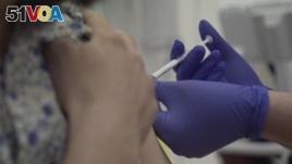 Screen grab from video released by Oxford University, showing a person being injected as part of the first human trials to test a possible coronavirus vaccine, untaken by Oxford University in Britain on April 23, 2020.