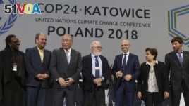 Heads of the delegations react at the end of the final session of the COP24 summit on climate change in Katowice, Poland, Dec. 15, 2018.