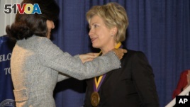 Senator Hillary Rodham Clinton receives her medal after being named to the National Women's Hall of Fame in Seneca Falls, N.Y.