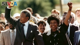 FILE - In this Feb. 11, 1990 file photo, Nelson Mandela and his wife, Winnie Madikizela-Mandela, raise clenched fists as they walk hand-in-hand upon his release from prison in Cape Town, South Africa. (AP Photo/Greg English, File)