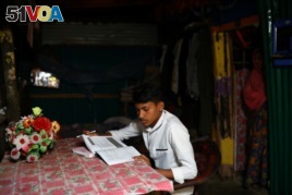 Kefayat Ullah, a Rohingya boy who was expelled from Leda High School for being a Rohingya, studies in his shelter in Leda camp in Teknaf, Bangladesh, March 5, 2019. REUTERS/Mohammad Ponir Hossain