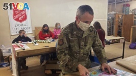 Chief Master Sgt. Winfield Hinkley Jr., Command Senior Enlisted Leader of the Alaska National Guard, wraps a gift in Anchorage, Alaska, that will be sent to a child in one of three rural Alaska villages, on Nov. 17, 2020.