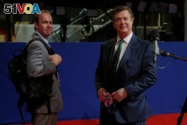 FILE - Paul Manafort, right, campaign manager to Republican Presidential Candidate Donald Trump, and his assistant Rick Gates stand on the floor of the Republican National Convention in Cleveland, July 17, 2016.