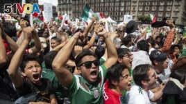 Fans celebrate Mexico's win during the Mexico vs. Germany World Cup football match, as they watched it on an outdoor screen in Mexico City, Mexico, June 17, 2018.