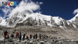 In this 2015 file photo, hikers rest at Mount Everest Base Camp in Nepal. Many goals, like climbing a mountain, require hard work, planning and many small steps to achieve. (AP Photo/Tashi Sherpa, file)
