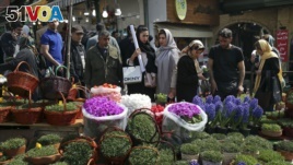 Iranians shop for hyacinths, garlic, sprouts and other items used to celebrate the Iranian New in northern Tehran. (March 19, 2018.)