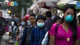 People wearing masks to protect themselves against the swine flu virus in Yangon, Myanmar, July 2017. (AP Photo/Thein Zaw)
