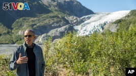 President Barack Obama speaks to members of the media while on a hike to the Exit Glacier in Seward, Alaska, Sept. 1, 2015.  (AP Photo/Andrew Harnik)
