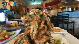The salt and pepper crab is one of the popular dishes on the menu at the Houston-based restaurant, Crawfish & Noodles, which specializes in Vietnamese-Cajun styled seafood.