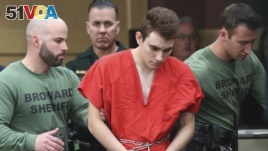 Nikolas Cruz is lead into the courtroom before being arraigned at the Broward County Courthouse in Fort Lauderdale, Fla., on Wednesday, March 14, 2018. (Amy Beth Bennett/South Florida Sun-Sentinel via AP, Pool)