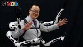 Masahiko Inami of the University of Tokyo poses with the wearable Jizai Arms robot arms at his lab during its demonstration in Tokyo, Japan, June 22, 2023. (REUTERS/Kim Kyung-Hoon)