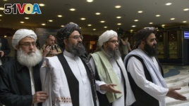 FILE - In this May 28, 2019 file photo, Mullah Abdul Ghani Baradar, the Taliban group's top political leader, second left, arrives with other members of the Taliban delegation for talks in Moscow, Russia.