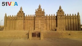 The world's largest mud-brick building, the Great Mosque of Djenne, Mali, awaits its annual replastering, Friday, May 10, 2024. (AP Photo/Moustapha Diallo, File)