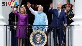 First lady Jill Biden, India's Prime Minister Narendra Modi and President Joe Biden waves from the Blue Room Balcony during an Arrival Ceremony on the South Lawn of the White House, Thursday, June 22, 2023, in Washington. (AP Photo/Manuel Balce Ceneta)