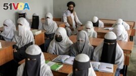 FILE - Afghan girls attend a religious school, which remained open since the last year's Taliban takeover, in Kabul, Afghanistan, on Aug. 11, 2022. (AP Photo/Ebrahim Noroozi, File)