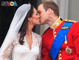 The first kiss: Prince William kisses his wife Kate, Duchess of Cambridge on the balcony of Buckingham Palace. (AP Photo)