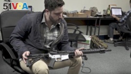 Gun rights activist Cody Wilson, director of Defense Distributed, holds a weapon at his Ghost Gunner factory in Austin, Texas. (YouTube)