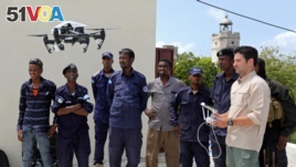 FILE - Somali police officers watch a drone demonstration in May 25, 2017. (REUTERS/Feisal Omar)