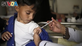 FILE - A boy receives a diphtheria vaccine at a hospital in Sanaa, Yemen, Sept. 9, 2019.