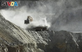 In this Sept. 25, 2012 photo, a bulldozer works at the Chuquicamata copper mine in the Atacama desert in northern Chile.