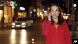 Dutch-Turkish journalist Ebru Umar talks on her mobile phone in Kusadasi, Turkey, Monday, April 25, 2016. Umar, a columnist for The Netherlands' Metro newspaper, has been barred from leaving Turkey. 