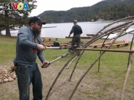 Iraq War veteran Michael Carroll, assisting in building the frame for a sweat lodge under the direction of Blackfeet Indian cultural advisors. Courtesy: Michael Carroll.