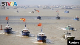 Fishing boats are seen departing from Shenjiawan port in Zhoushan, Zhejiang province towards the East China Sea fishing grounds, September 17, 2012.